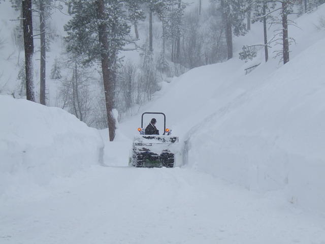 Curtis is havig a hard time to clear the driveway. He may eventually have to use the tractor bucket to push the snow burm down t