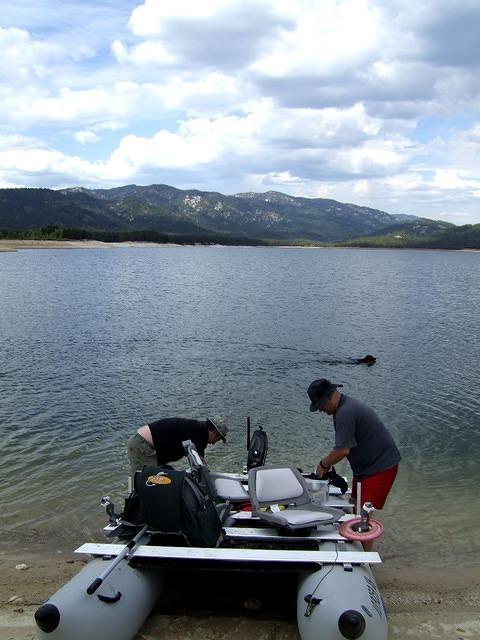 Lowering the motor and moving seats is being done. Buster is going for a swim.