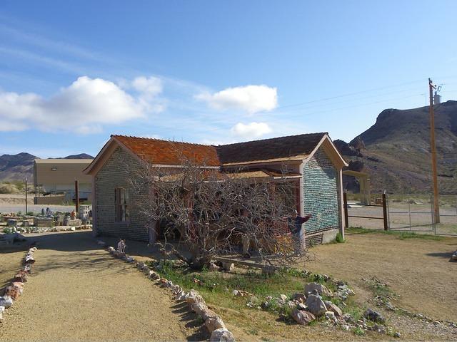 A house built of 30,000 beer bottles has been partially restored though.