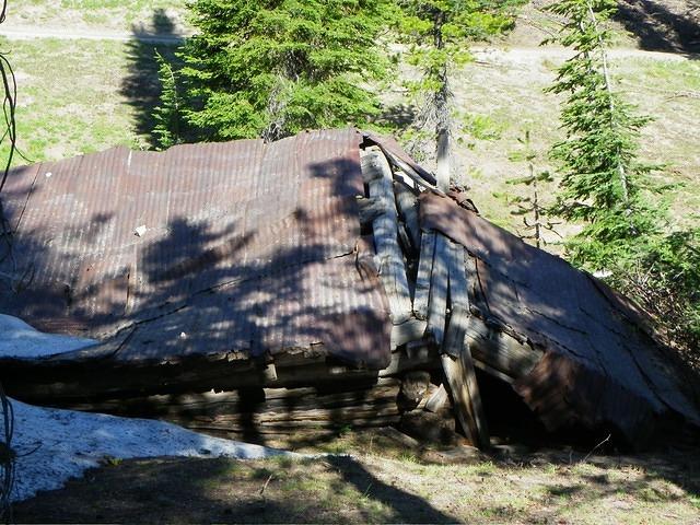 An old shelter lies in ruins on the mountain top.