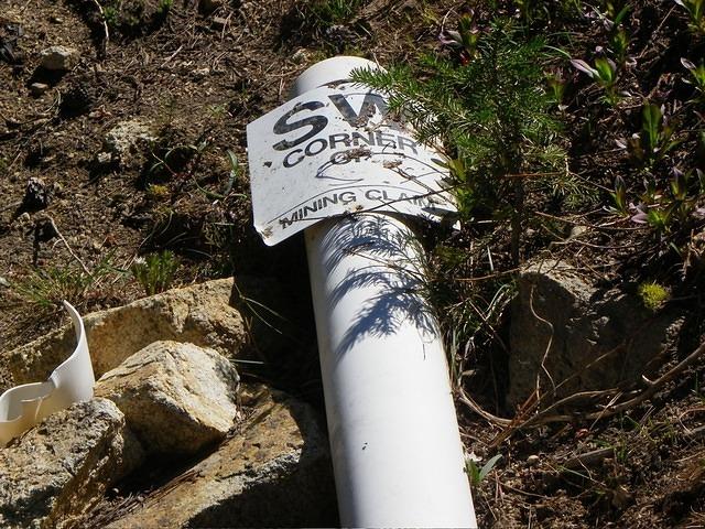 A fallen sign to a mining claim.