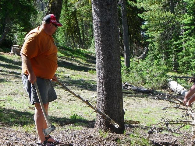 Christian carrrying a little stick, hopefully to move the tree laying in the road ahead of him.