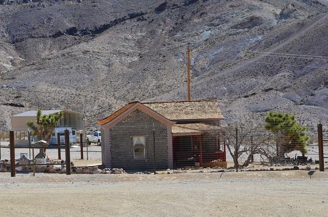 A house made of used beer and wine bottles. 