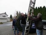 Kent, Jim (Patty's son) and Curtis putting up an enormous wreath.
